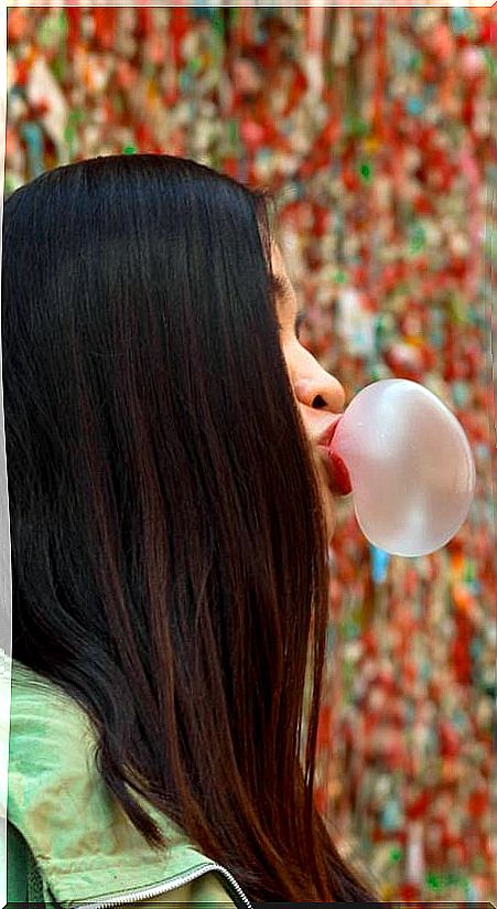 Girl making a bubble gum balloon